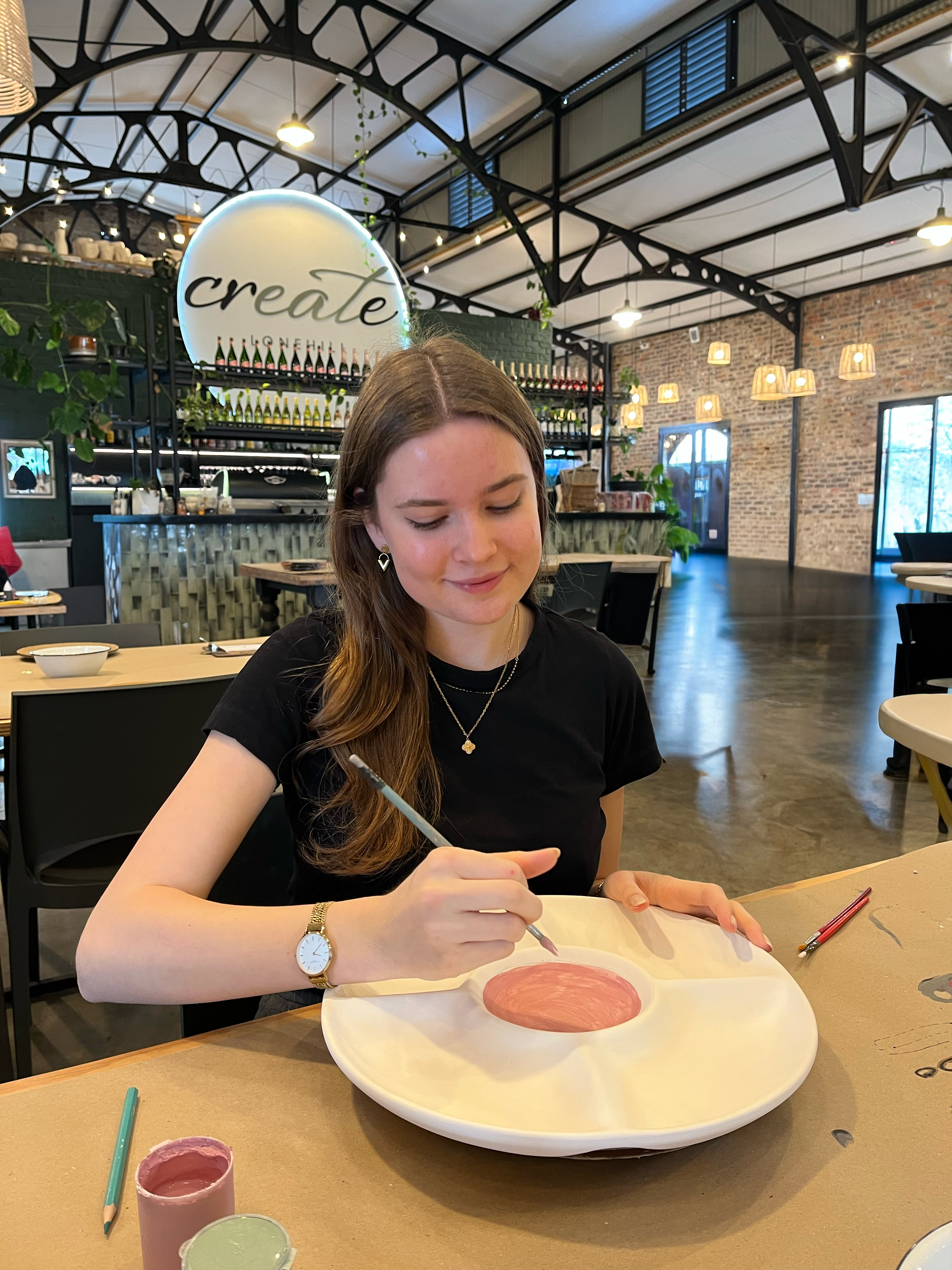 Dianthe painting a ceramic plate